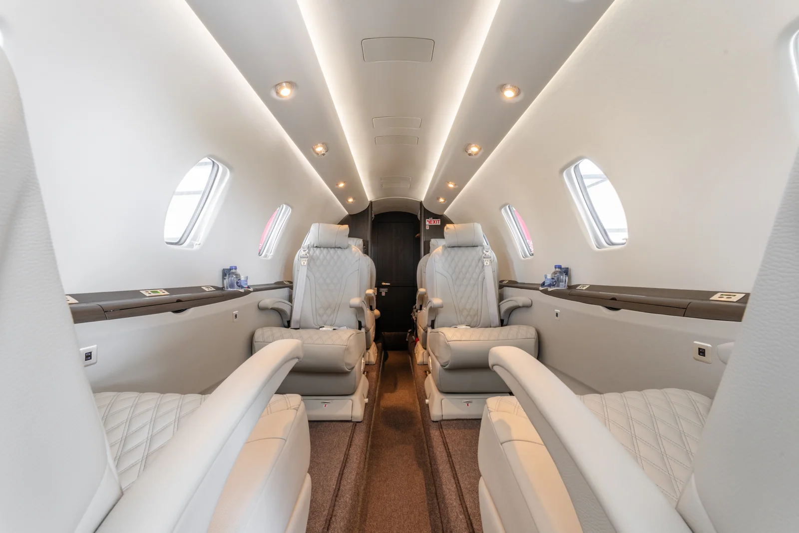 After: the completed Citation XLS cabin, with coordinated finishes and a durable dark carpet.