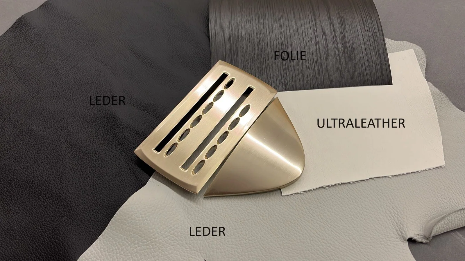 Material selection: upholstery and surface samples alongside the control panels and trim.