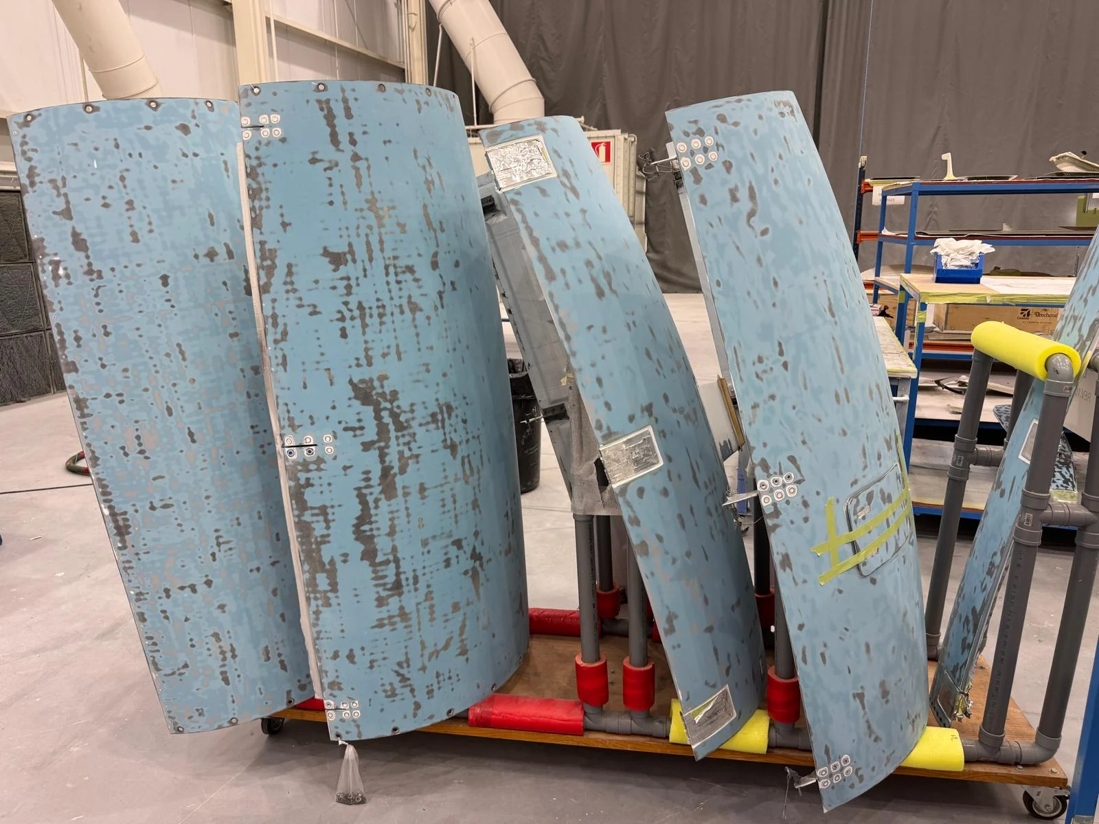During the work: removed engine cowlings being prepared for painting.