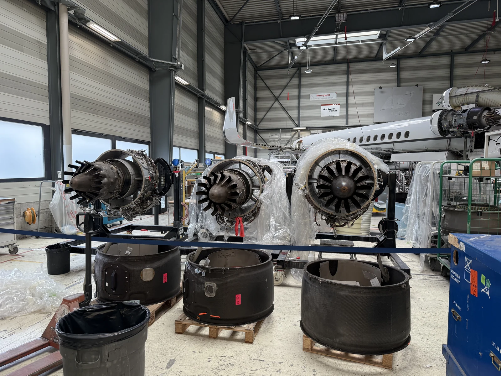 Engines and removed cowlings in the workshop during the Falcon 7X 2C inspection.