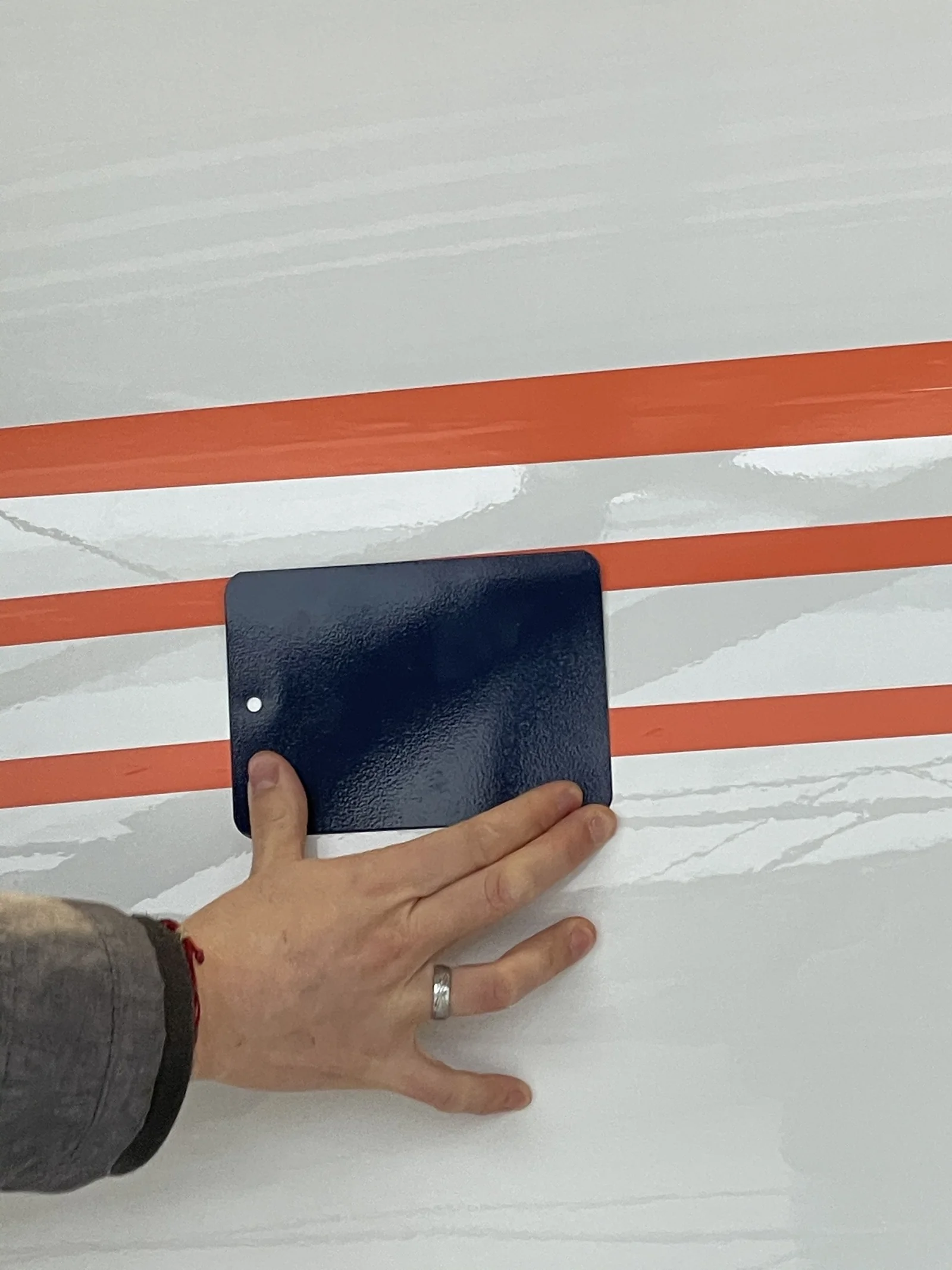 During design review: a colour sample against the taped-out lines of the new paint scheme.